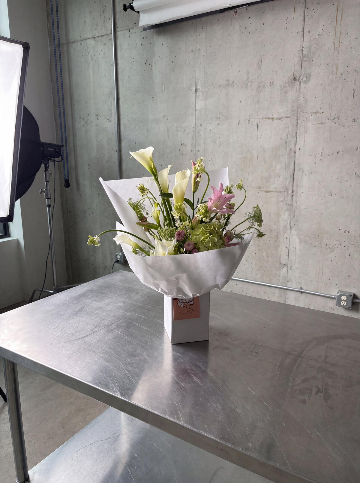 Calla Me Maybe, detail view 2. Airy sculptural bouquet built around statement calla lilies and green hydrangea.