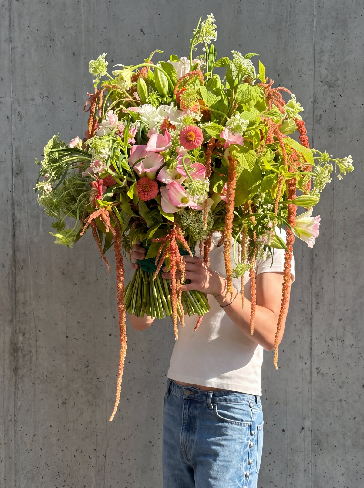 House Guest by WildMoon Flowers, Toronto. Oversized interior bouquet with cascading amaranthus, lilies and local field flowers.