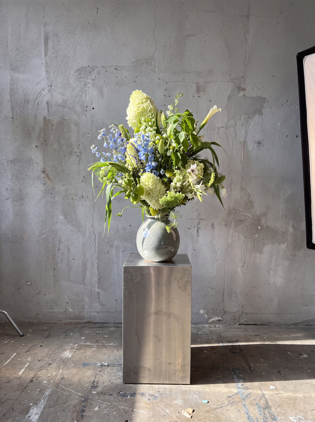 Blue Hour, detail view 2. Signature sculptural bouquet in soft blue, white and fresh green.
